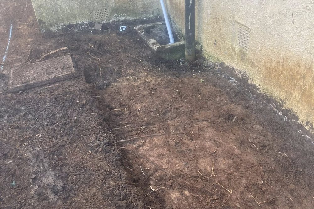 Before: side-path area excavated to expose drainage and soil